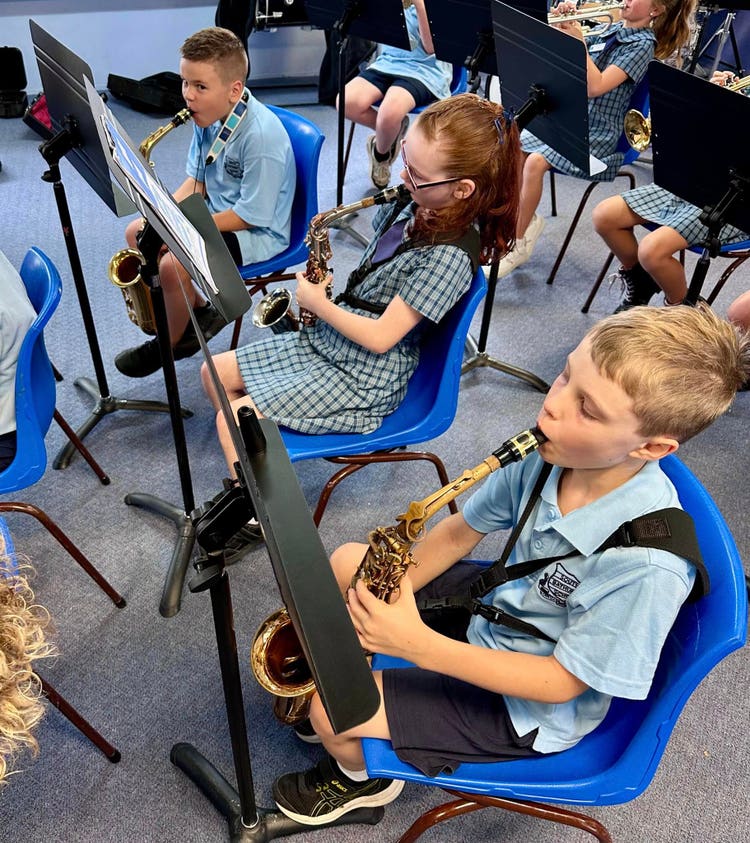 Students in band lessons, playing saxaphones