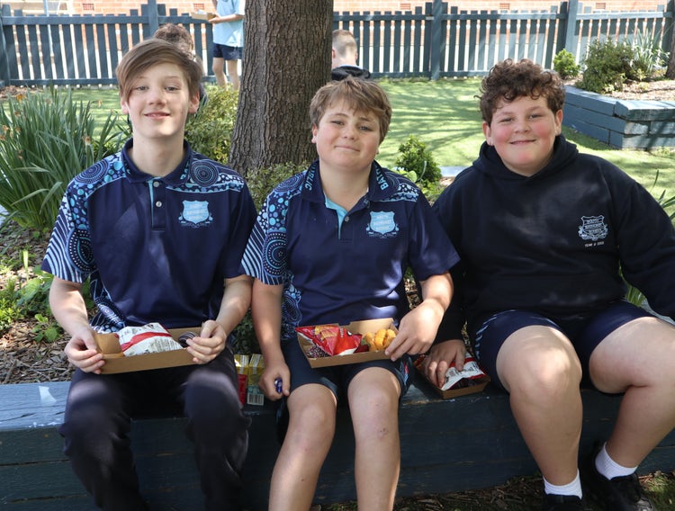 3 boys sitting in garden enjoying morning tea