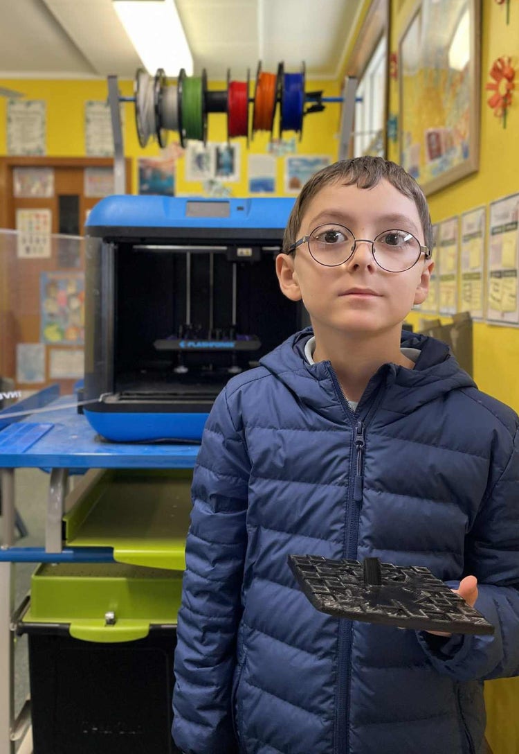 Student standing infront of 3D printer