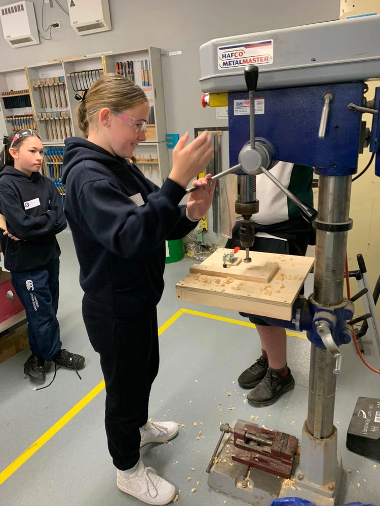 2 people, drill press