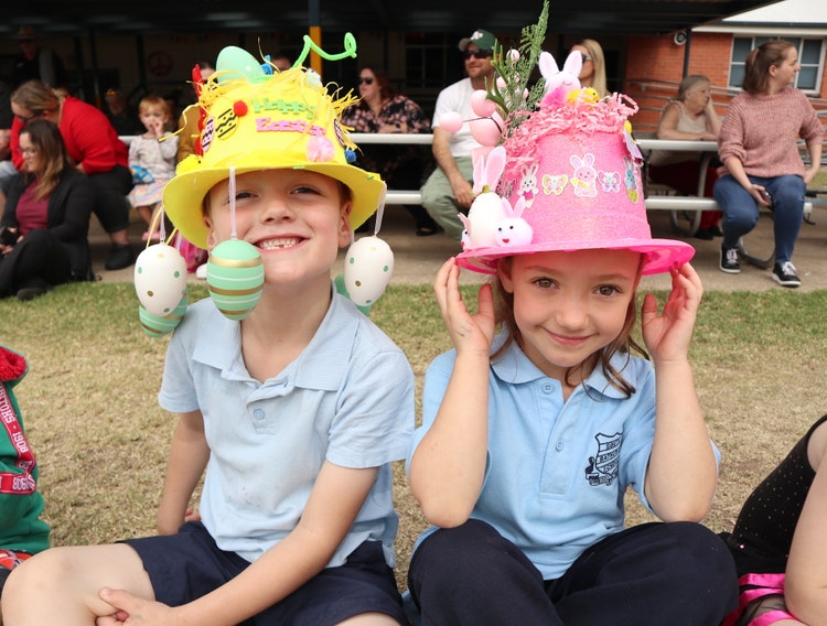 Two students smiling in Easter Hats