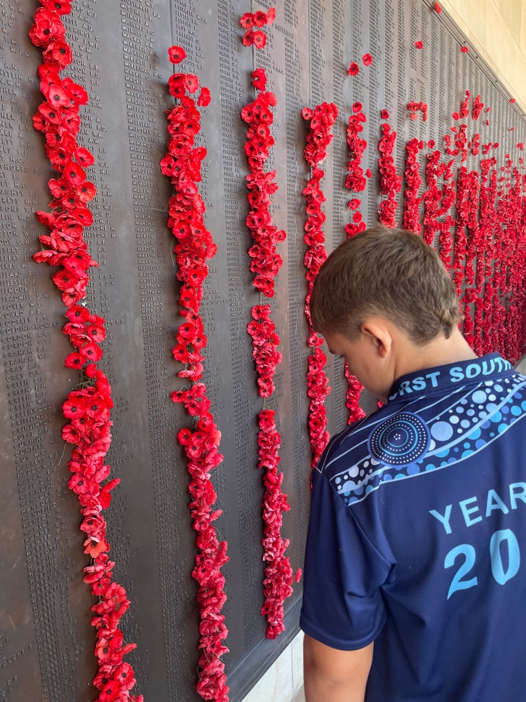 Student viewing names on War Memorial plaque