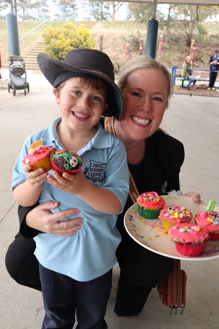Mother and son smiling with cupcakes